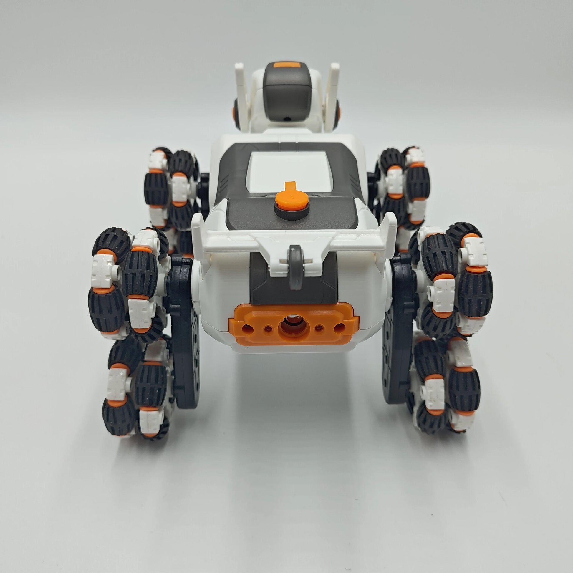 This electric remote-controlled smart robot dog kit includes a spray function, remote control, and accessories, perfect for children's exploration and entertainment.