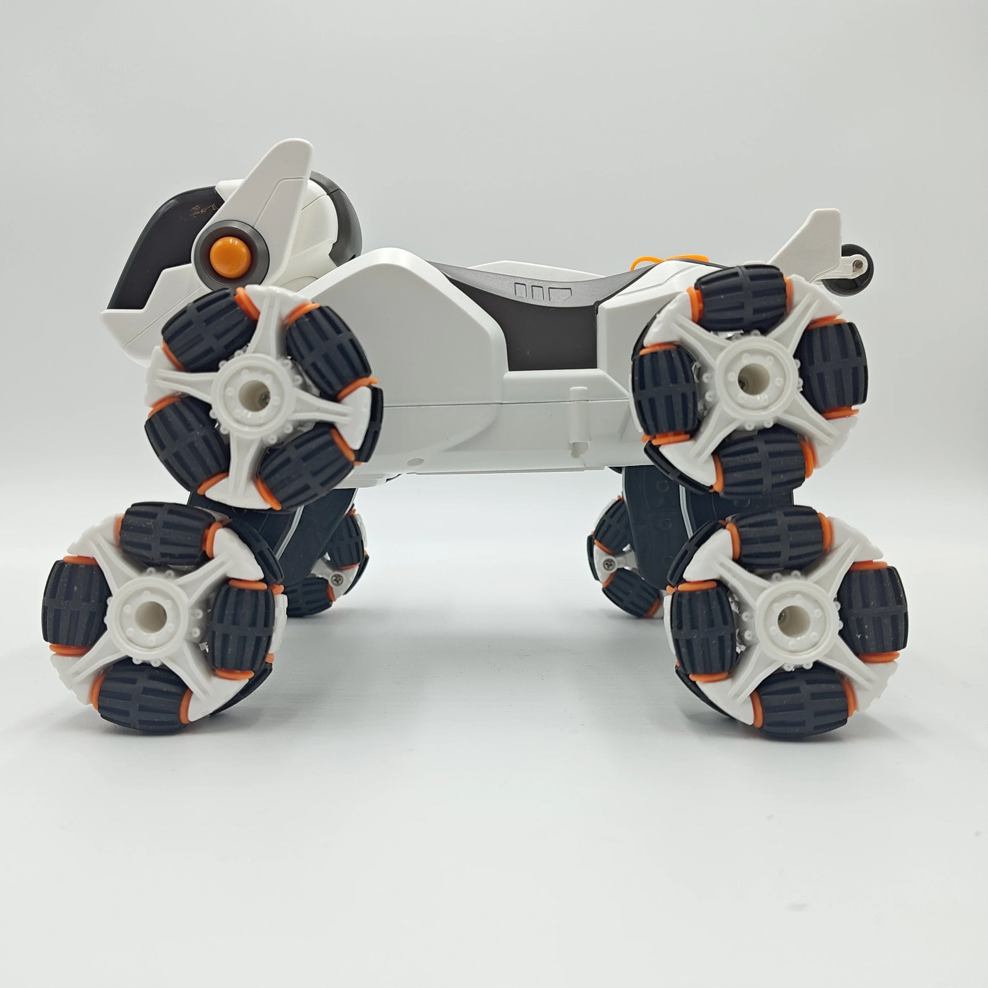 This electric remote-controlled smart robot dog kit includes a spray function, remote control, and accessories, perfect for children's exploration and entertainment.