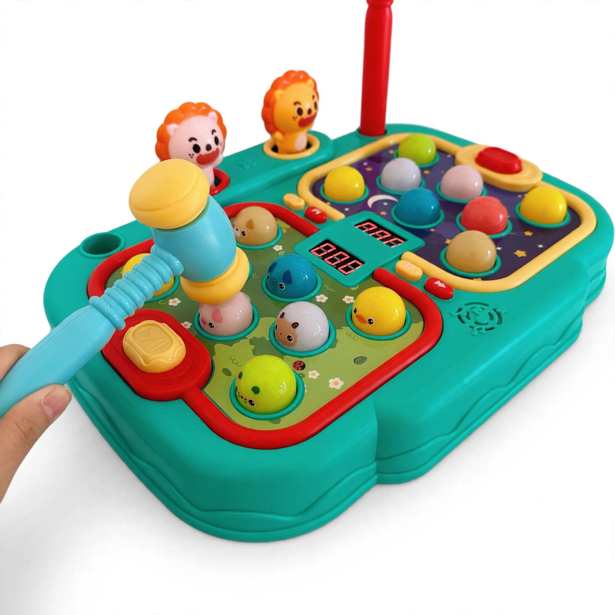 Close-up of a child tapping a light-up button with a soft hammer on the whack a mole game machine, practicing hand-eye coordination